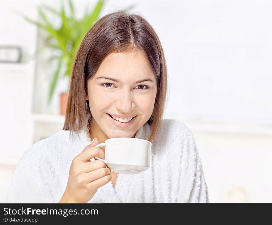 Woman In Bathrobe Relaxing At Home