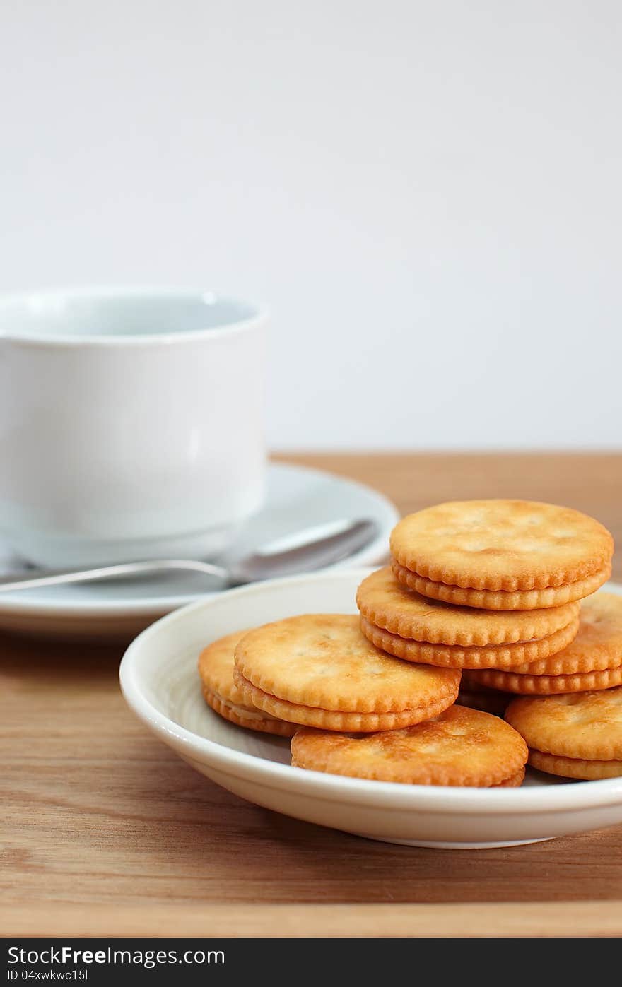 Cracker and a cup of coffee isolated on white background