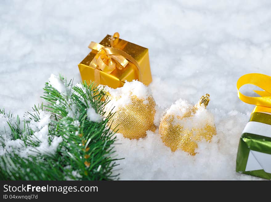 Gold  Christmas decoration  on snow. Gold  Christmas decoration  on snow