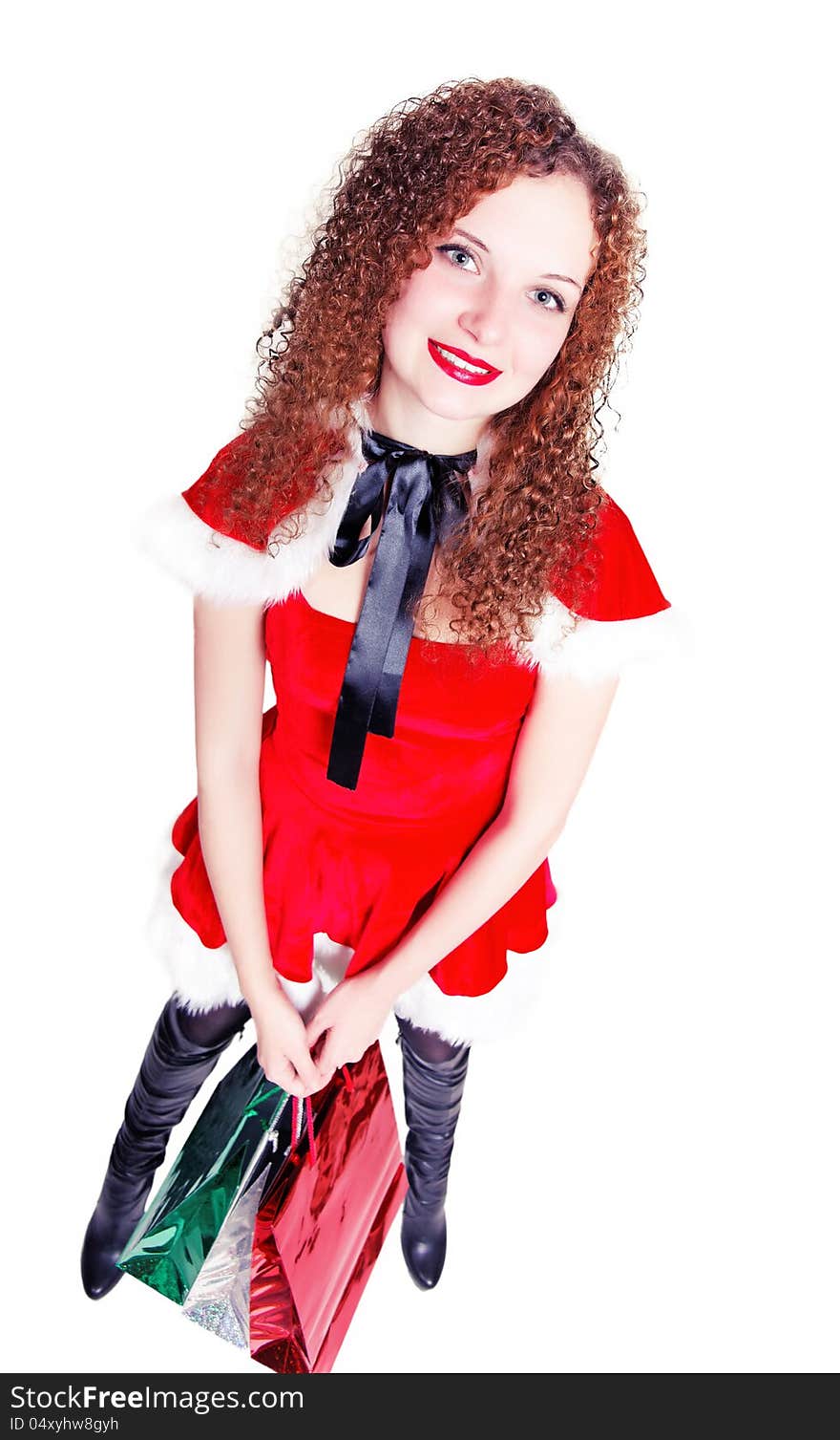 Pretty girl as Santa with shopping on an isolated