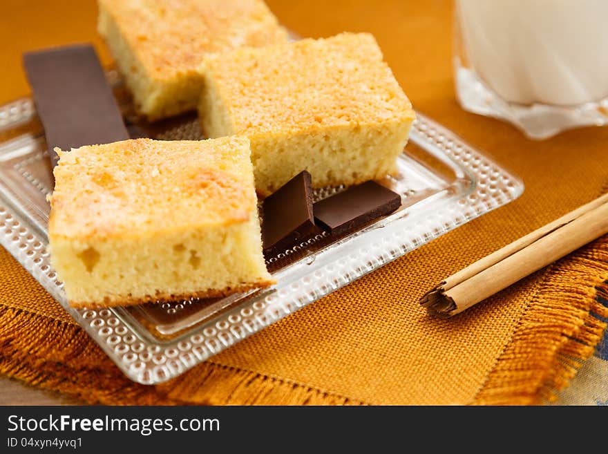 Portions of homemade cake with chocolate and glass of milk for breakfast or snack. Portions of homemade cake with chocolate and glass of milk for breakfast or snack