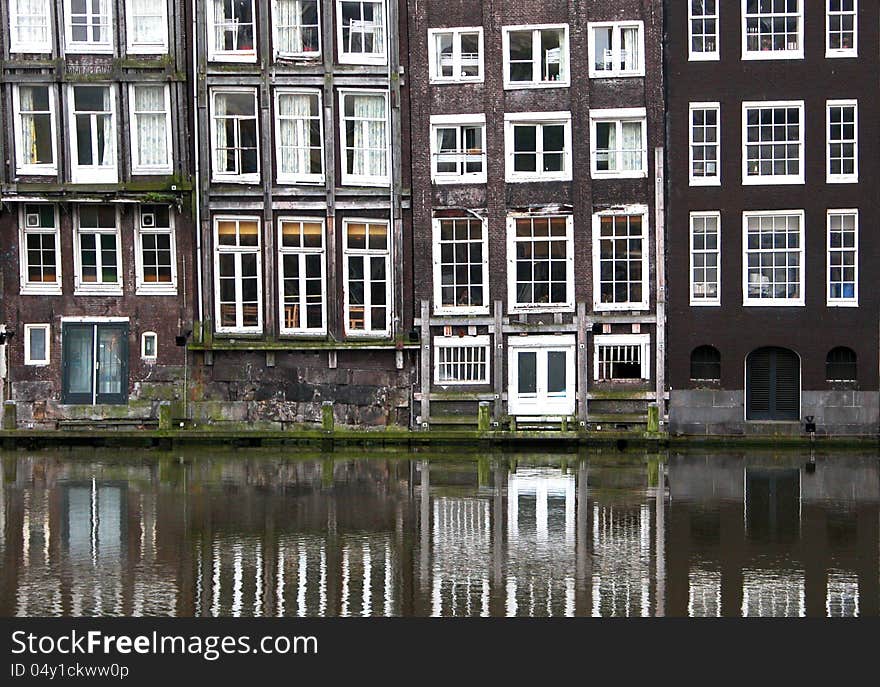 Symmetrical windows from a building in Amsterdam, Holland, Netherlands. Symmetrical windows from a building in Amsterdam, Holland, Netherlands.