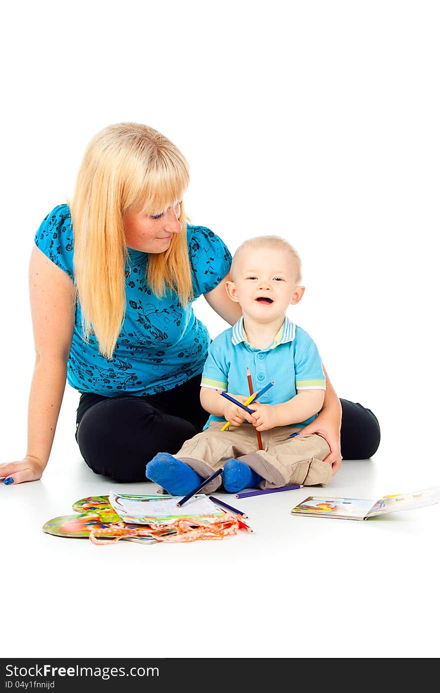 Mother with a child playing with pencils and paint. Mother with a child playing with pencils and paint