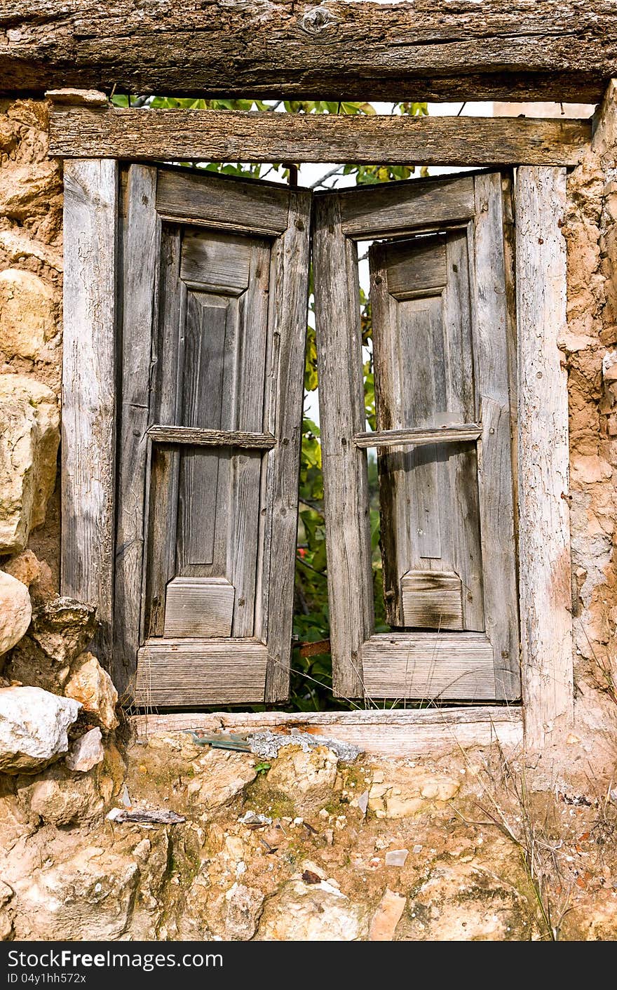 Old ruined closed wooden window