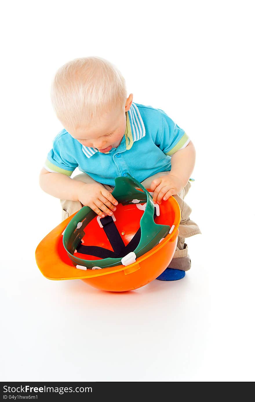 Little child plays with a helmet. Little child plays with a helmet