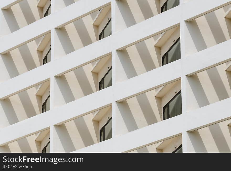 Building facade with window in angle view with light and shadow