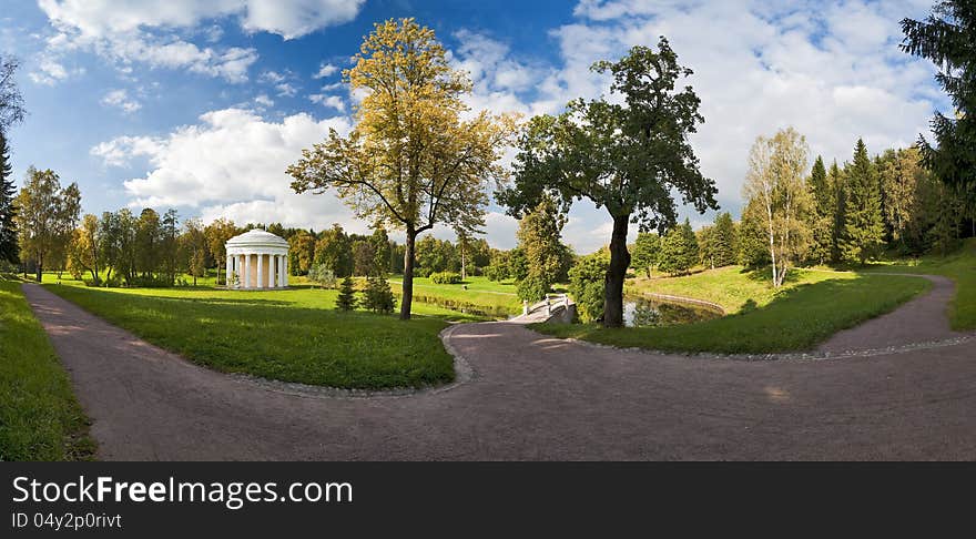 Panorama in the autumn park with classical bridge and rotunda