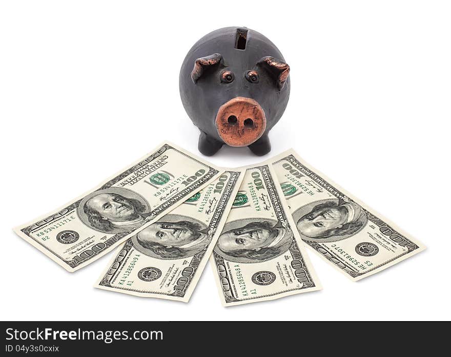 Money and black piggy bank on white background.