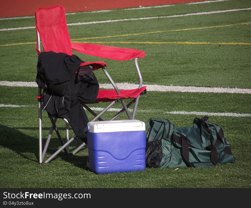 Chair and athletic gear on football field