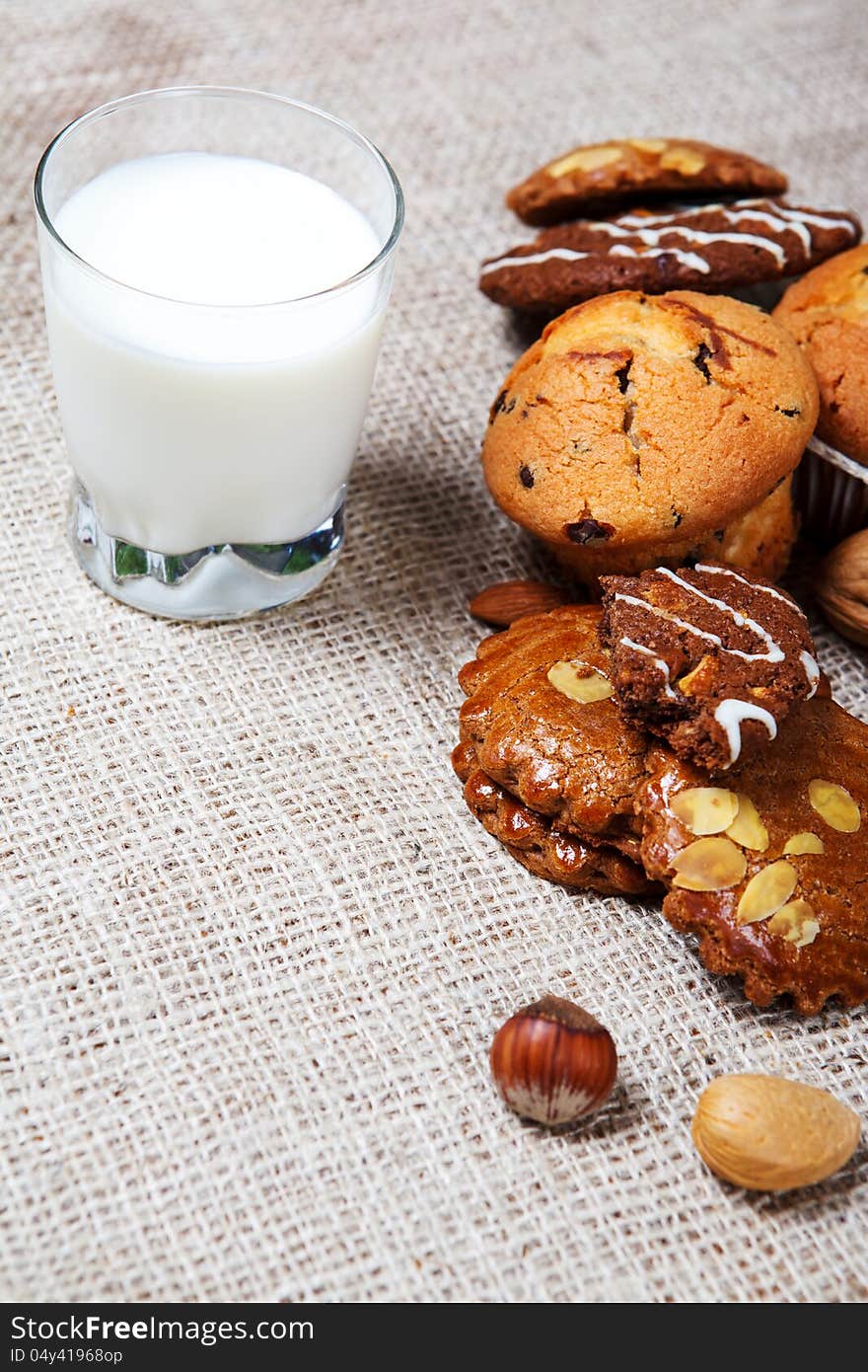 Biological sweet pastry and glass with milk on coarse fabric