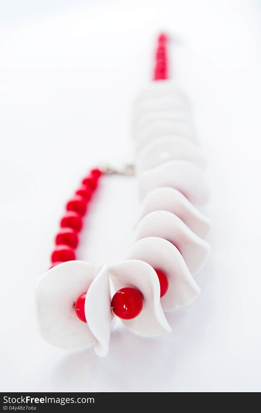 White and red necklace on a white background