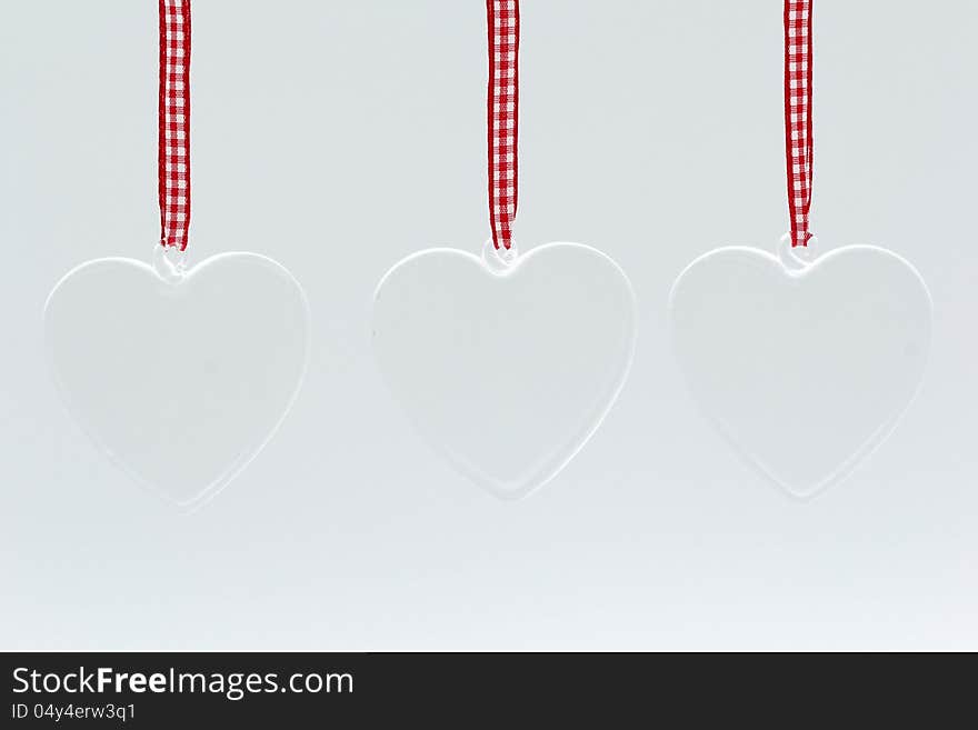 Glass hearts on white background