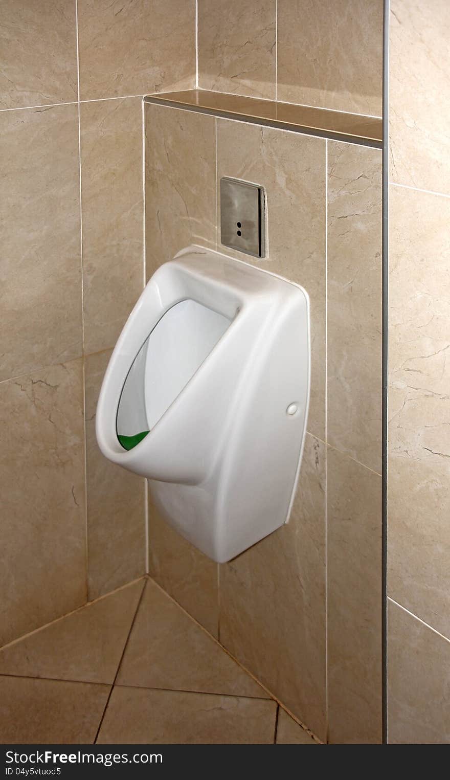 White urinal in a public toilet for men