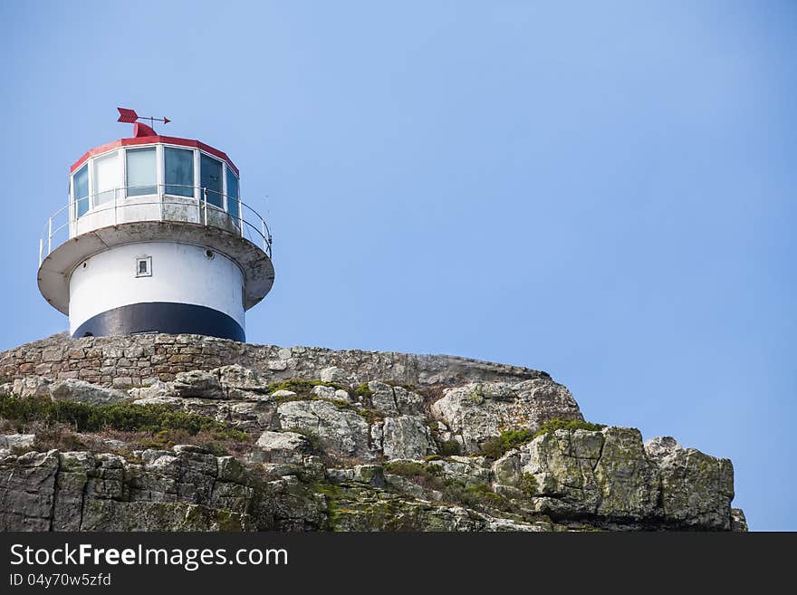 A  small light house on the top of the mountain.