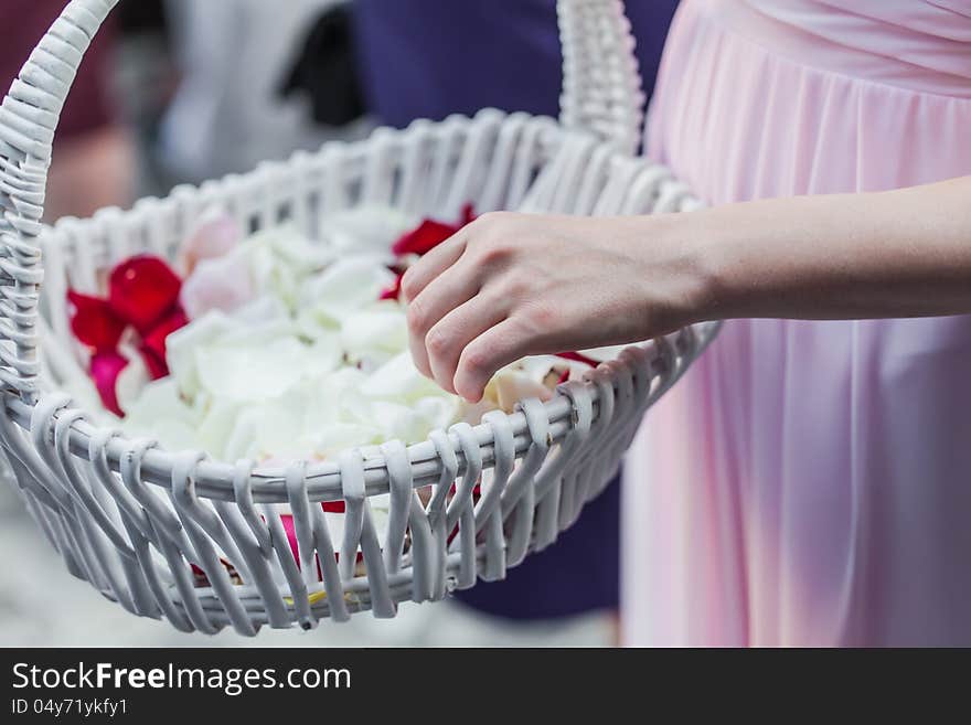 The flower girl need to throwsome rose pedals on the married couple.