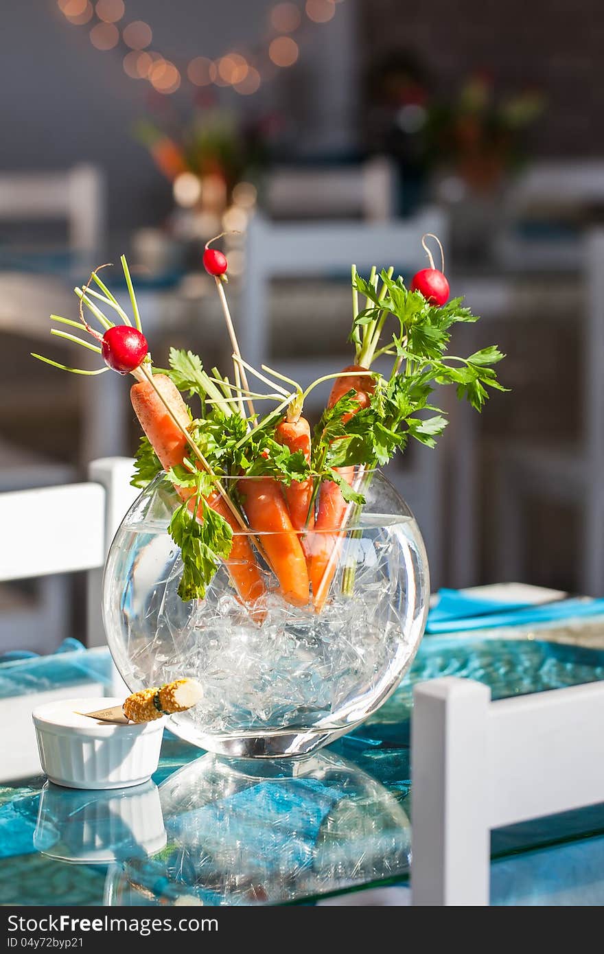 Carrot and berries ikebana decorations in a glass vase. Carrot and berries ikebana decorations in a glass vase.