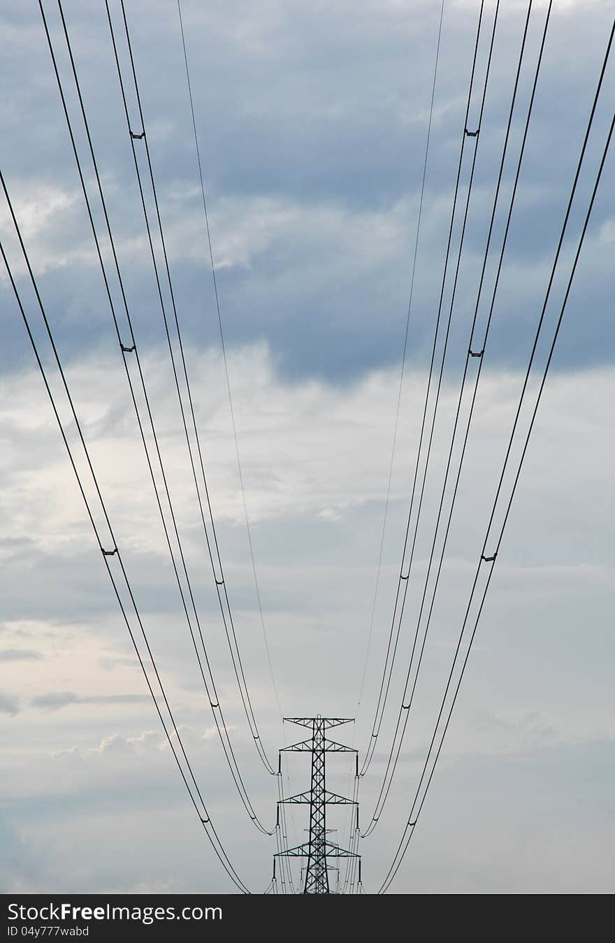 The electricity post and an electric line and back rucksack sky ground