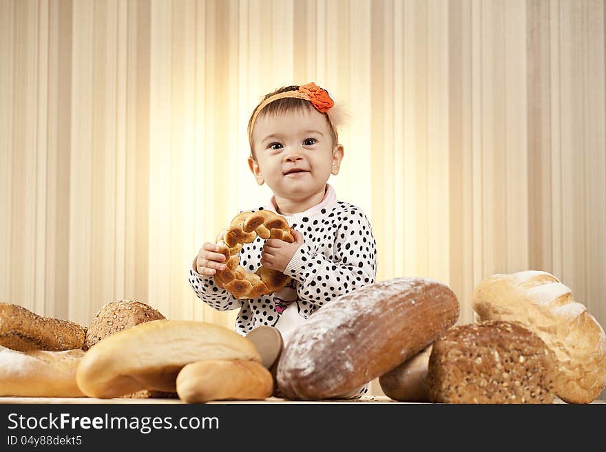 White infant choosing bread in studio. White infant choosing bread in studio