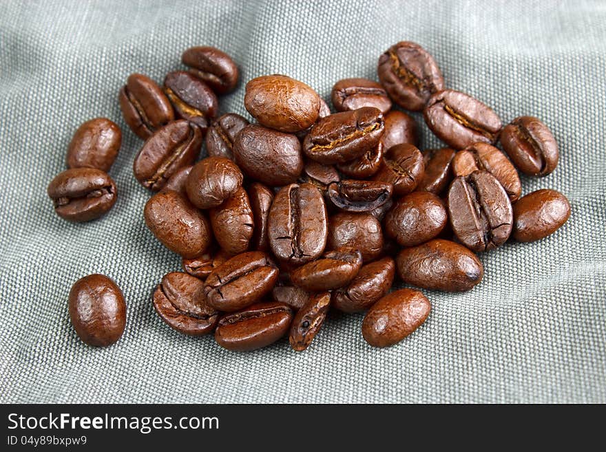 Coffee beans on fabric background