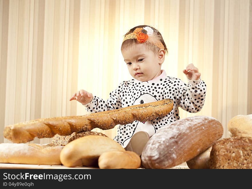 White infant choosing bread in studio. White infant choosing bread in studio