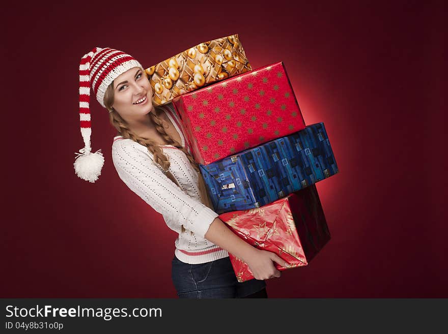 Studio shoot of woman with Santa hat  with presents isolated. Studio shoot of woman with Santa hat  with presents isolated