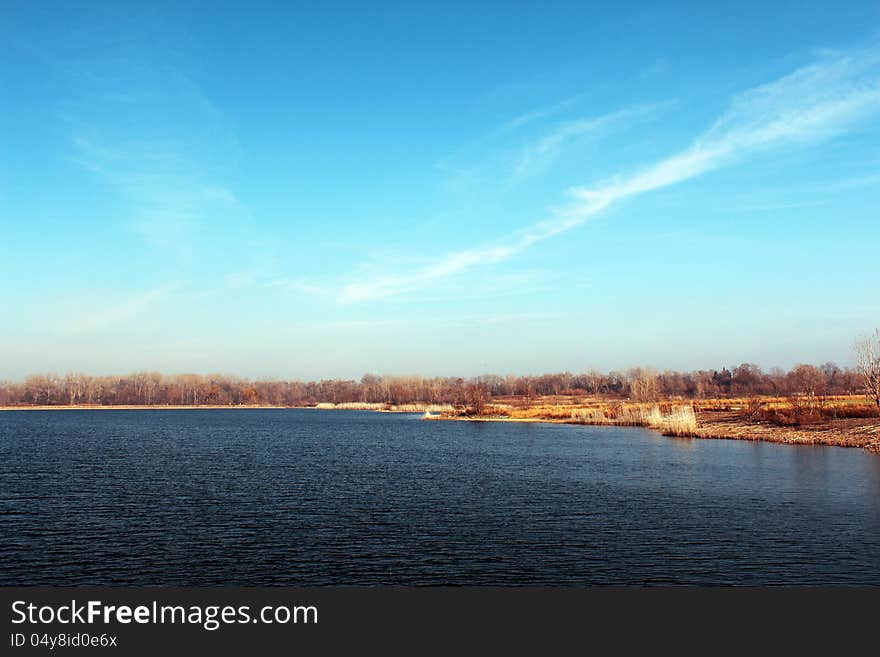 Blue sky and lake. Winter landscape without snow