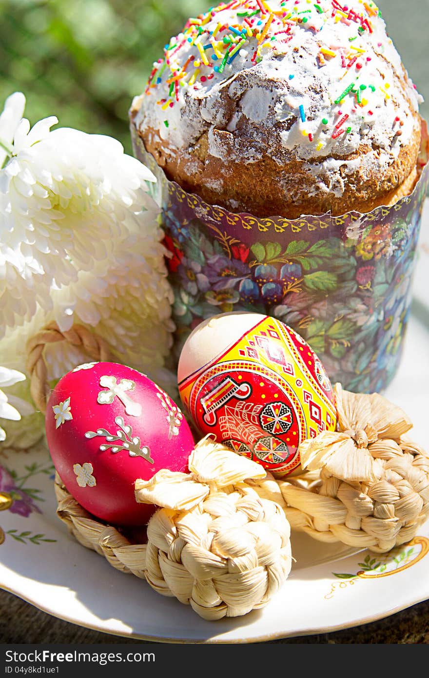 Easter cake with colorful eggs and flowers on plate