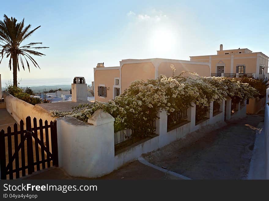 House by the sea, a fence with flowers, Greece