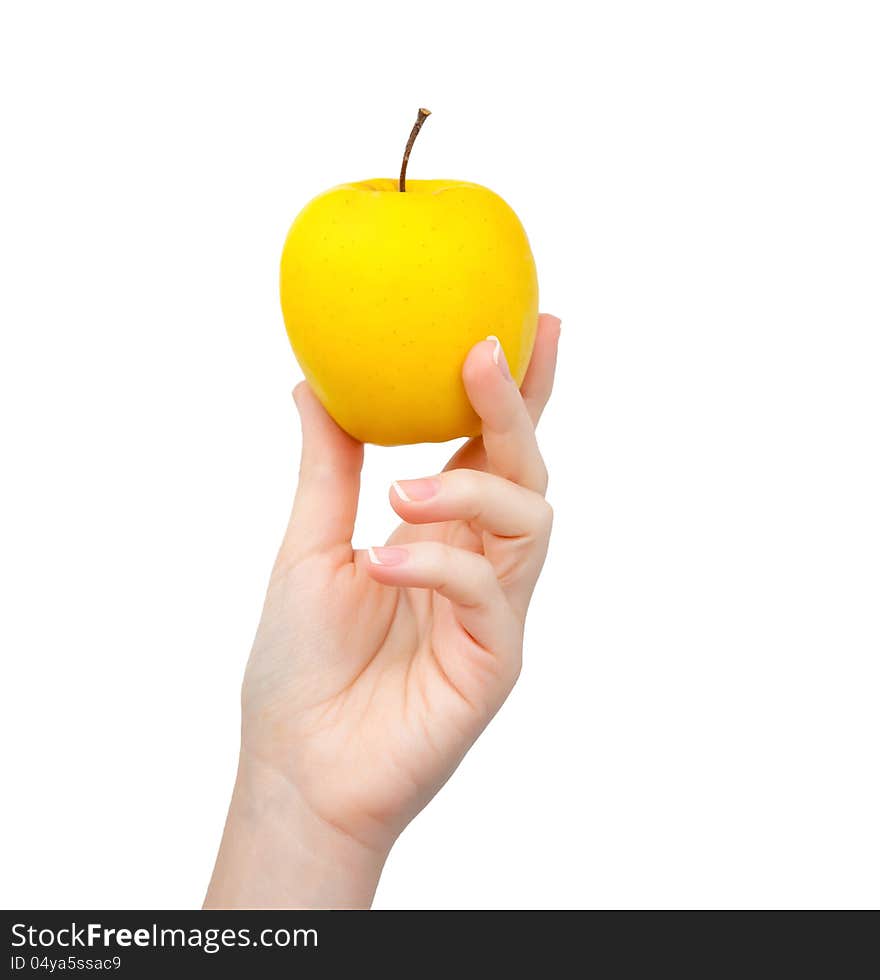 Woman hand on isolated background holding a yellow apple. Woman hand on isolated background holding a yellow apple