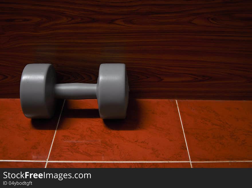 Lonely dumbbell on the floor. Lonely dumbbell on the floor