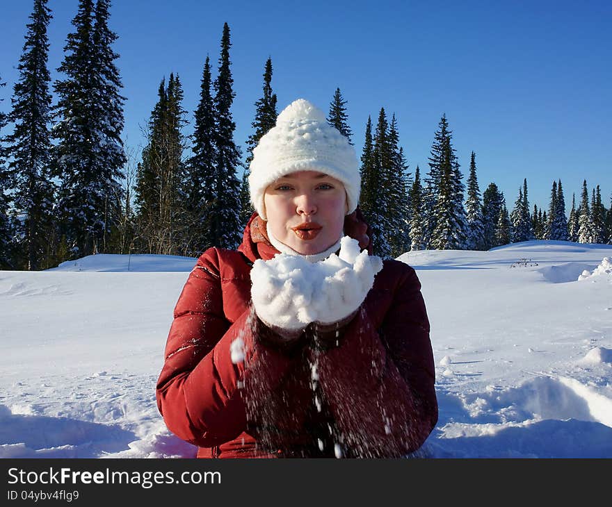 Girl is holding  snow on the hands.