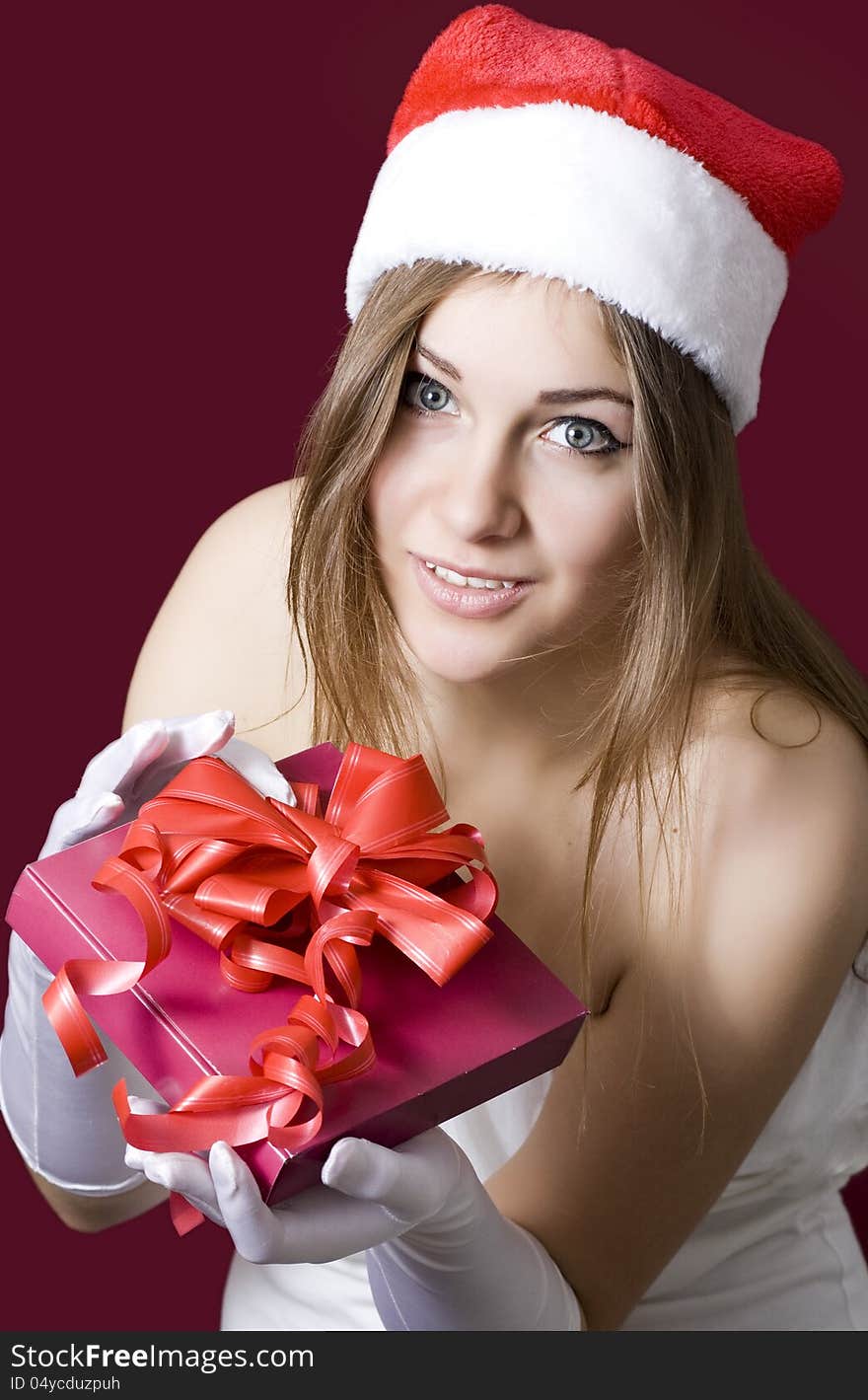 Young happy girl in Christmas hat.