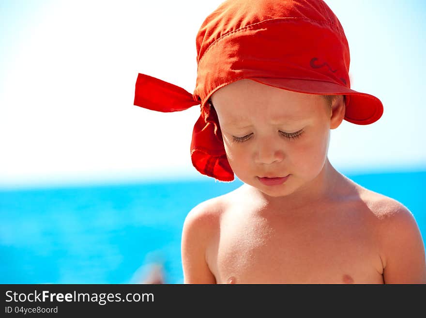 Thoughtful child on sea background