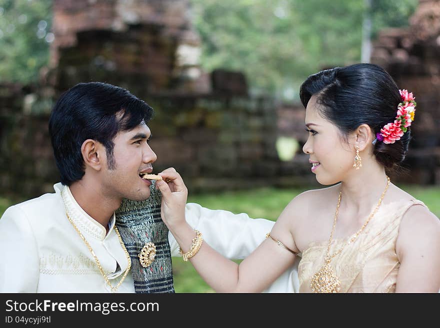 A Woman Feeding A Man Cookie