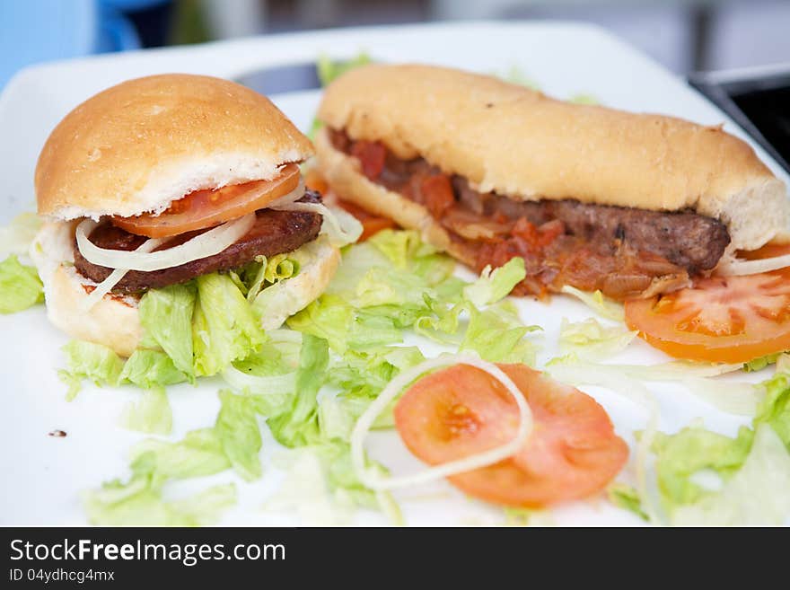 Hamburger and hotdog on white plate