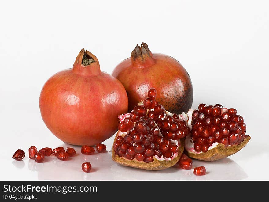 Pomegranate fruit and pomegranate grains on white background. Pomegranate fruit and pomegranate grains on white background