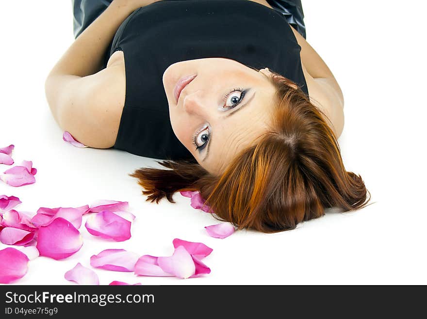 Beautiful girl with a rose and petals