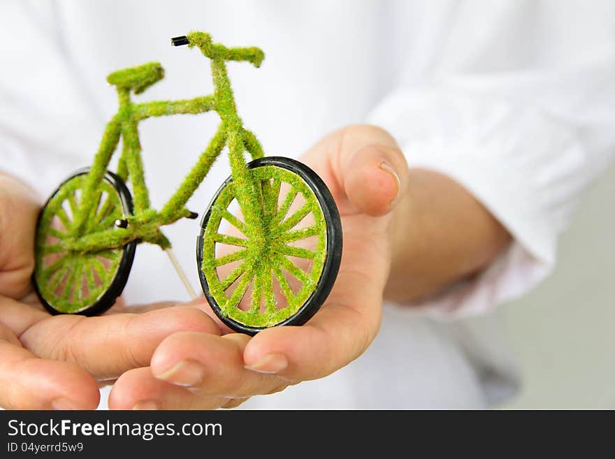 Hand holding eco bicycle icon