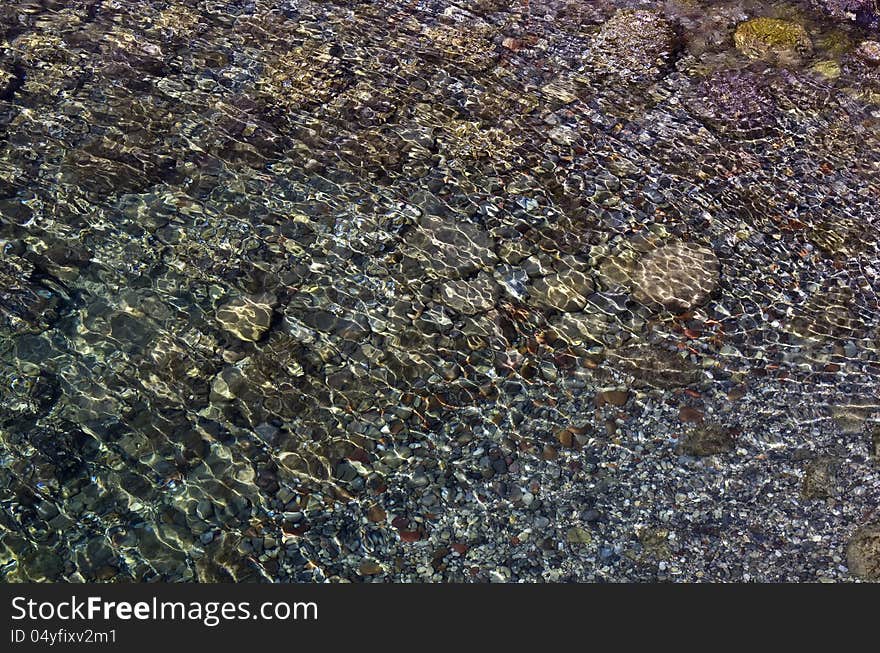 Pebbles on the seafloor in shallow water. Pebbles on the seafloor in shallow water