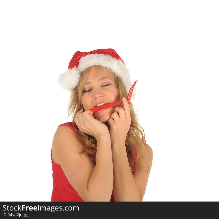 Attractive young woman in Santa Cap with chili pepper. isolated on white. Attractive young woman in Santa Cap with chili pepper. isolated on white.