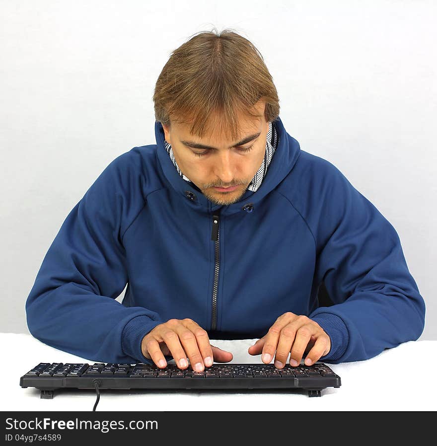 Front view of yong man looking at keyboard on white background. Front view of yong man looking at keyboard on white background