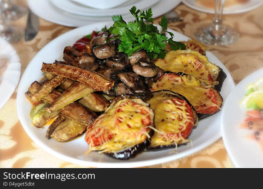 Vegetable baked under cheese slices , dekorated with parsleys. Vegetable baked under cheese slices , dekorated with parsleys