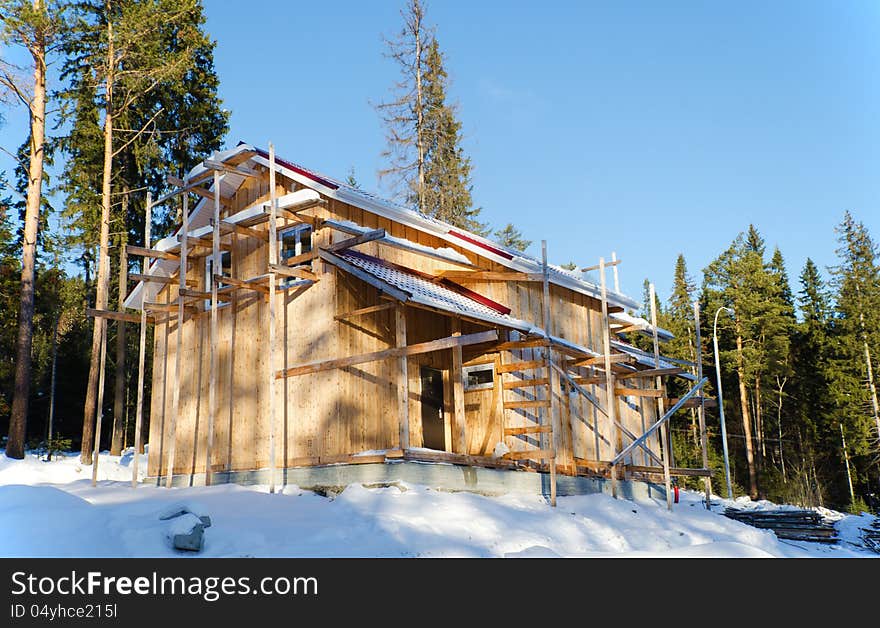 Recently constructed three country houses in wood in a sunny day against the blue sky