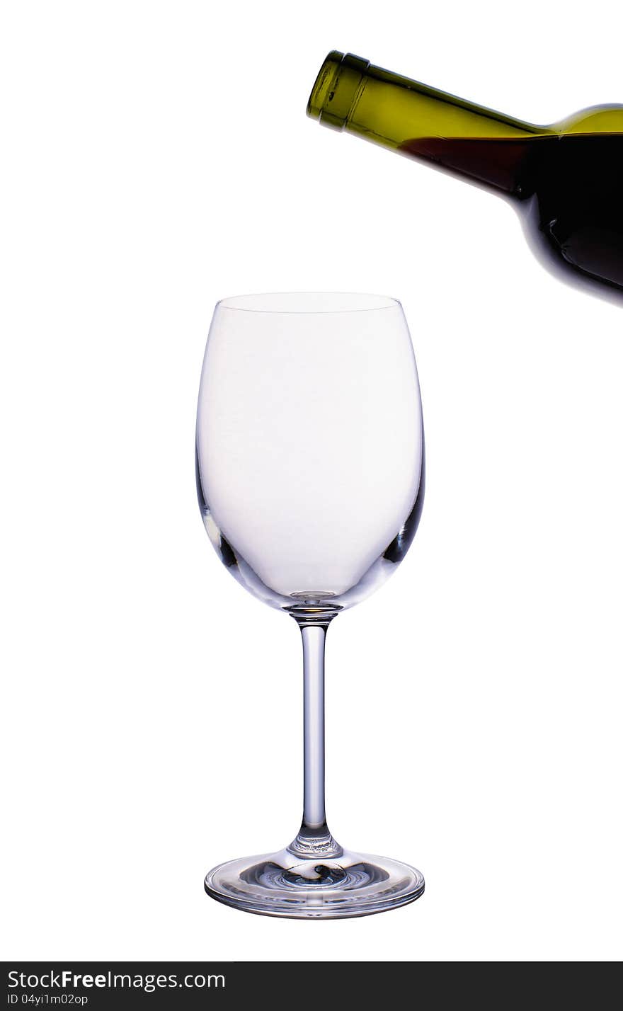 Empty wine glass and bottle of red wine isolated on white background