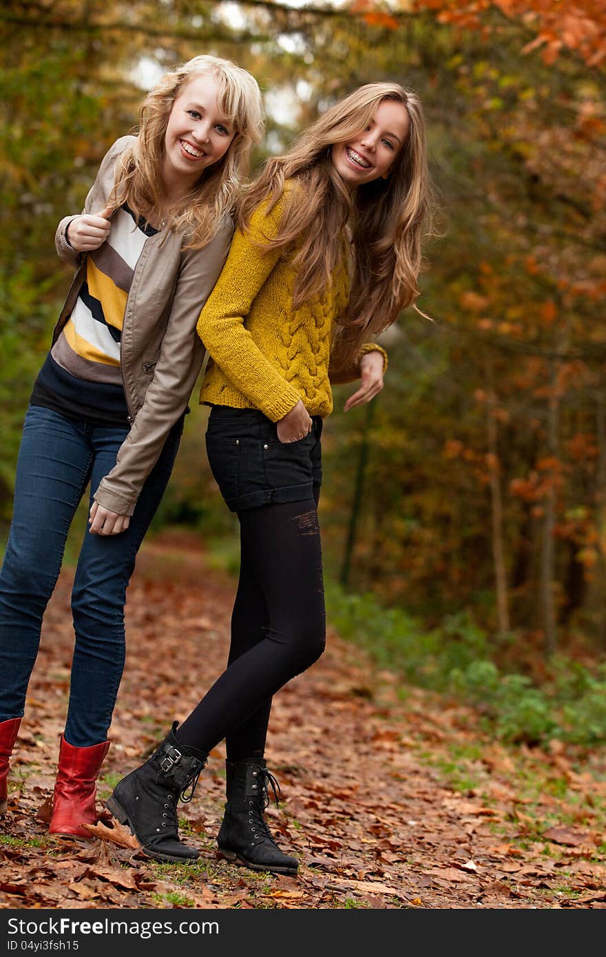 2 girls are having fun in the forest. 2 girls are having fun in the forest