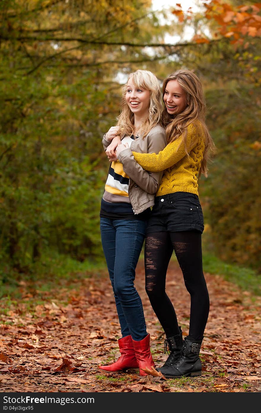 2 girls are having fun in the forest. 2 girls are having fun in the forest