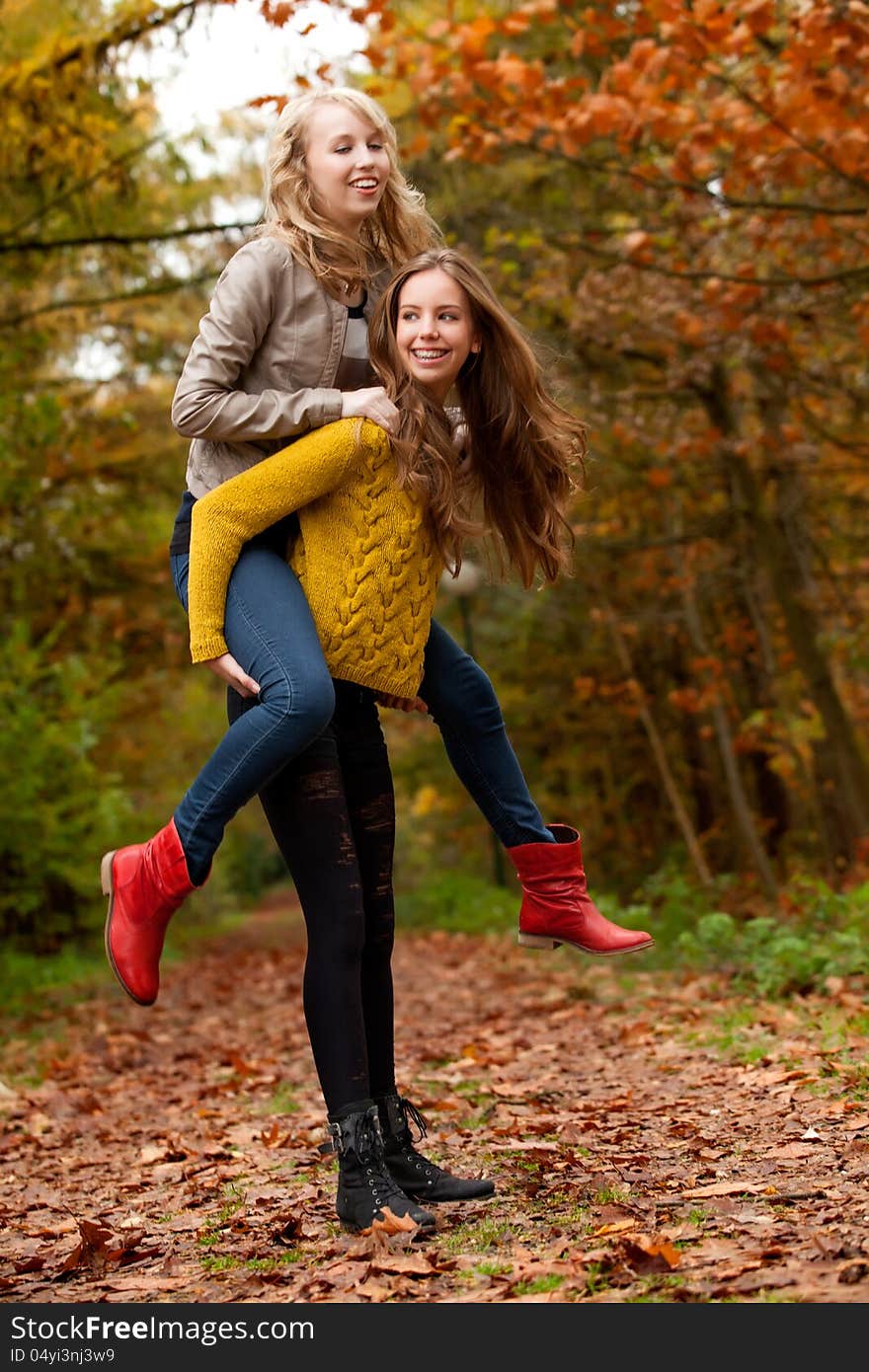 2 girls are having fun in the forest. 2 girls are having fun in the forest