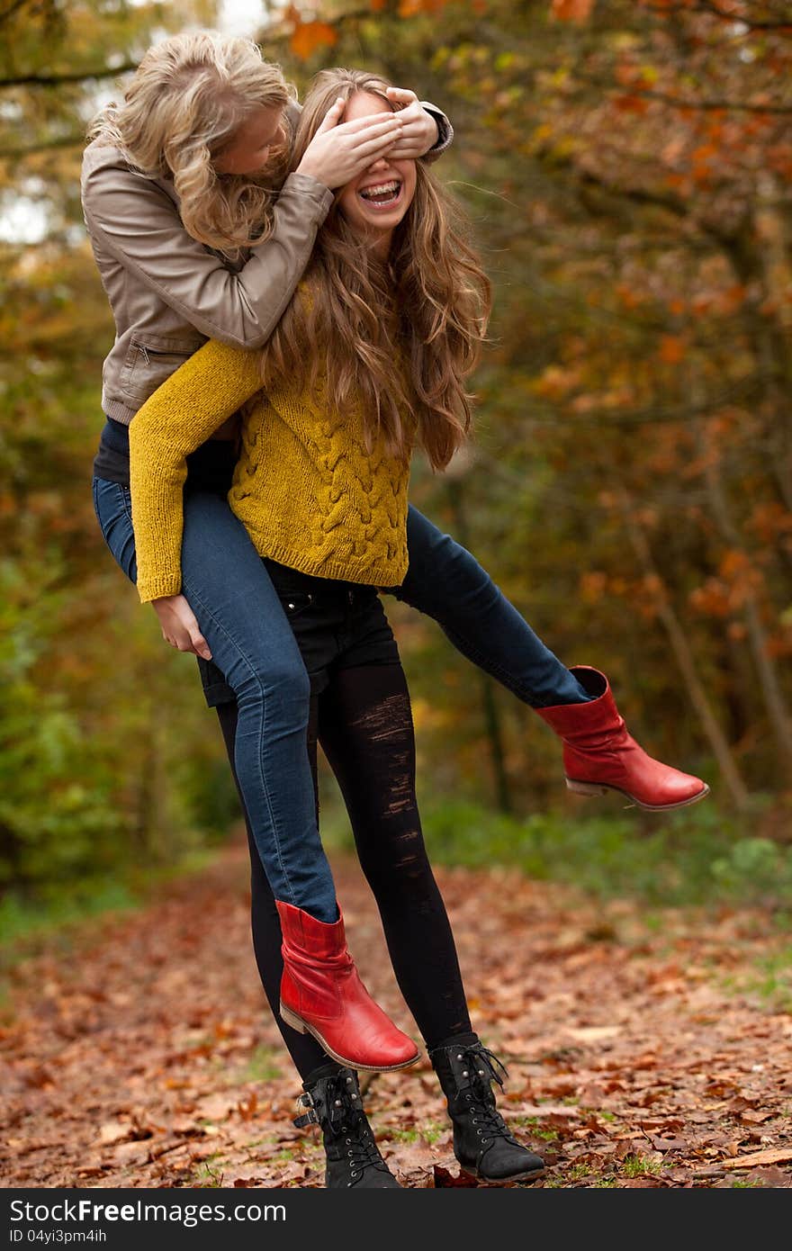 2 girls are having fun in the forest. 2 girls are having fun in the forest