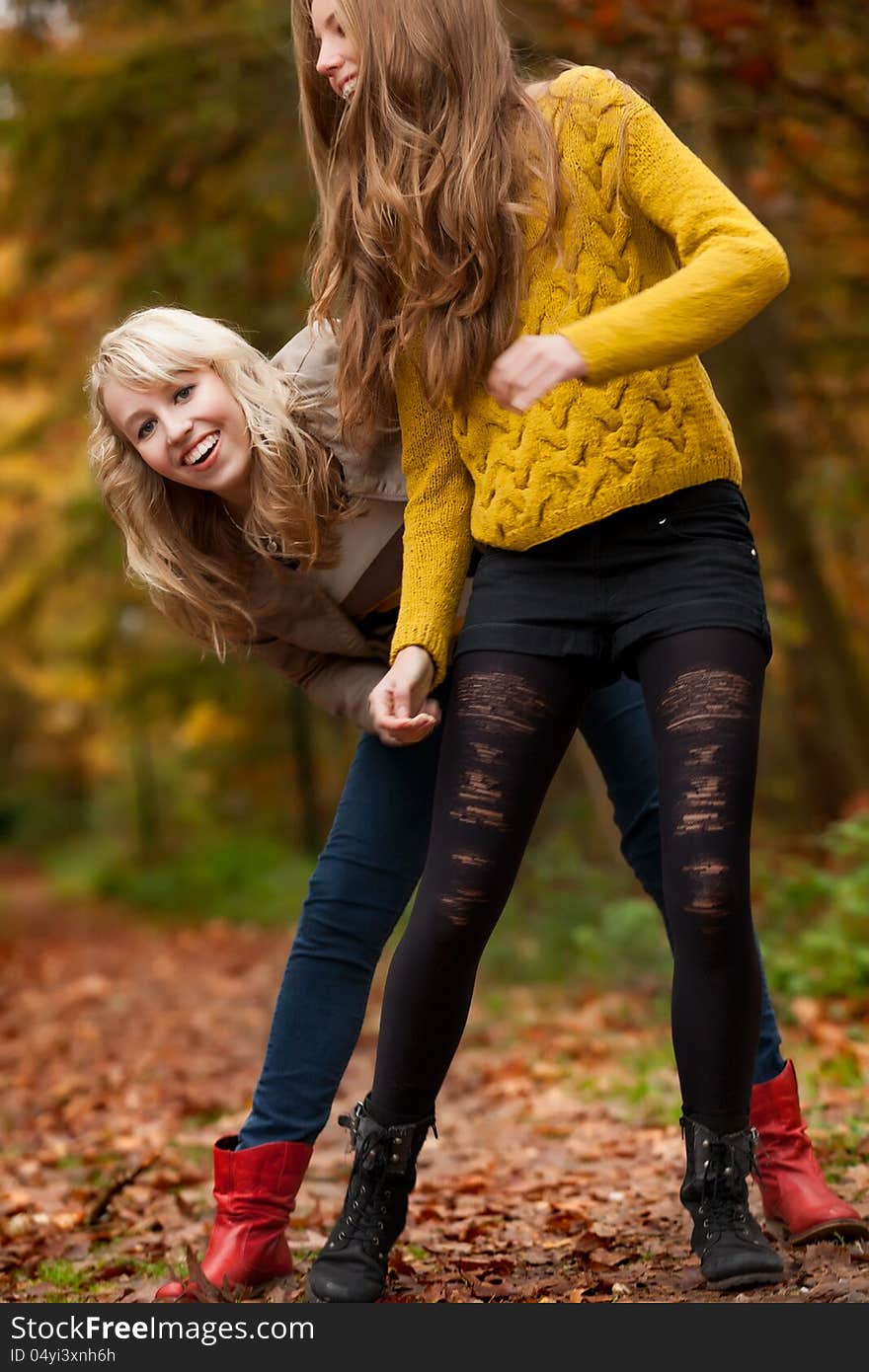 2 girls are having fun in the forest. 2 girls are having fun in the forest