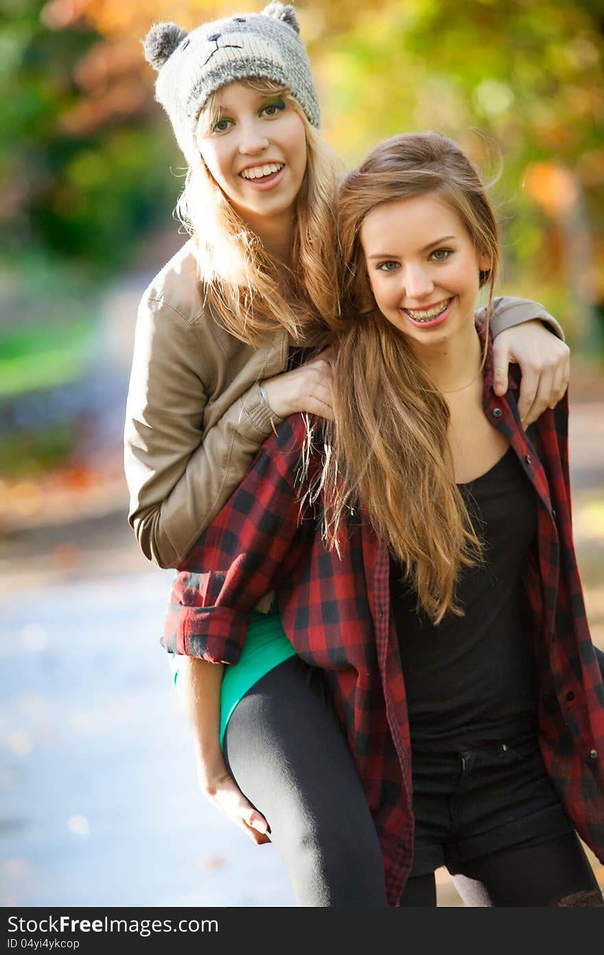 2 girls are having fun in the forest. 2 girls are having fun in the forest